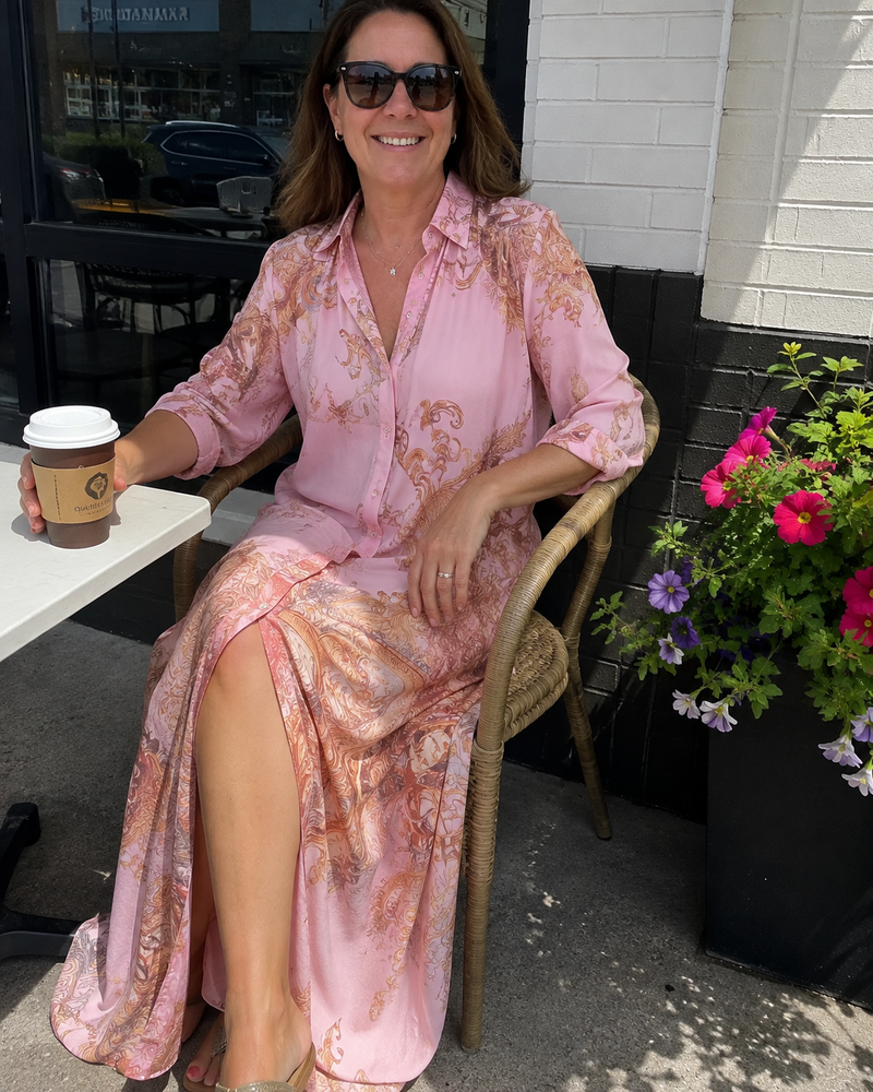 Customer photo: the pink dress worn at a pavement café table with a takeaway coffee, the skirt falling open over the knee.