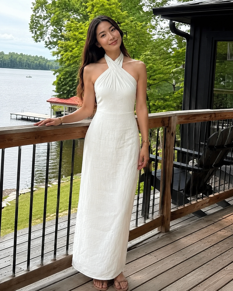 Customer photo: the Noelle dress in white on a lakeside deck, showing the waist seam and straight skirt