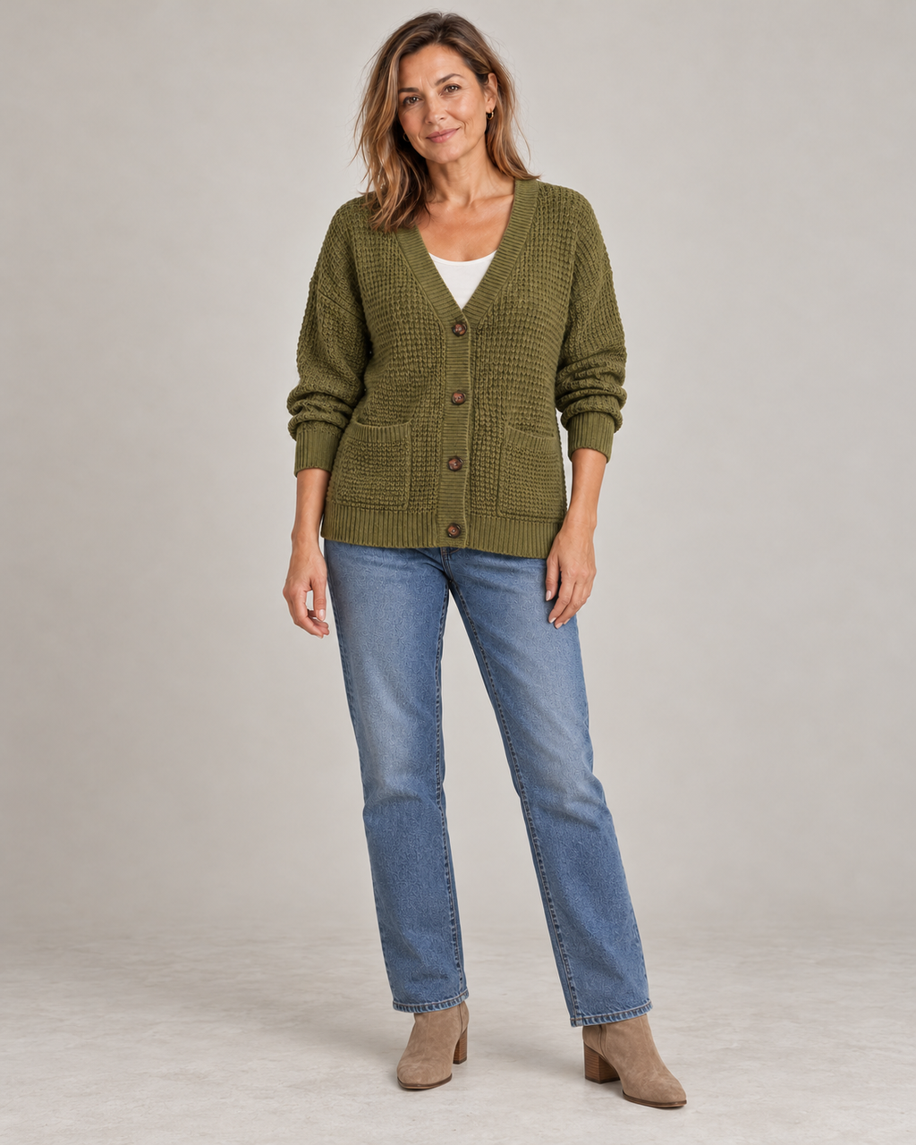 Full length, buttoned over a white tee with straight-leg jeans and ankle boots