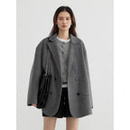 Agathe wool coat – grey, worn open over a grey cardigan