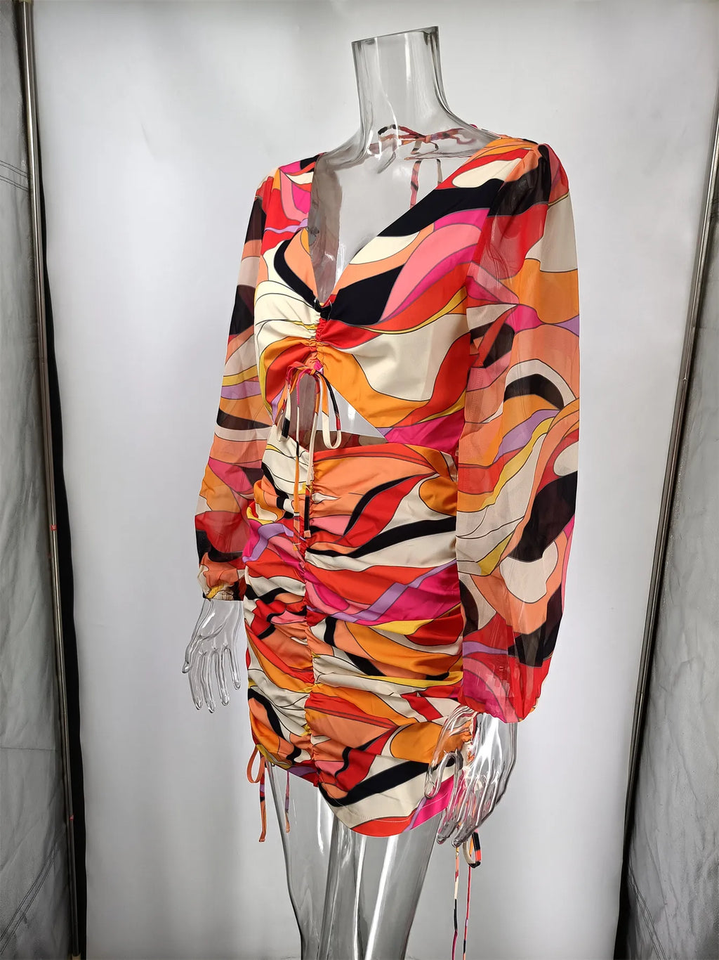 The Alma dress on a mannequin, showing the halter tie, the ruched body and the side drawstrings