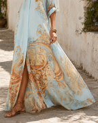 The skirt in motion, showing the slit opening below the last button and the baroque border filling the lower half.