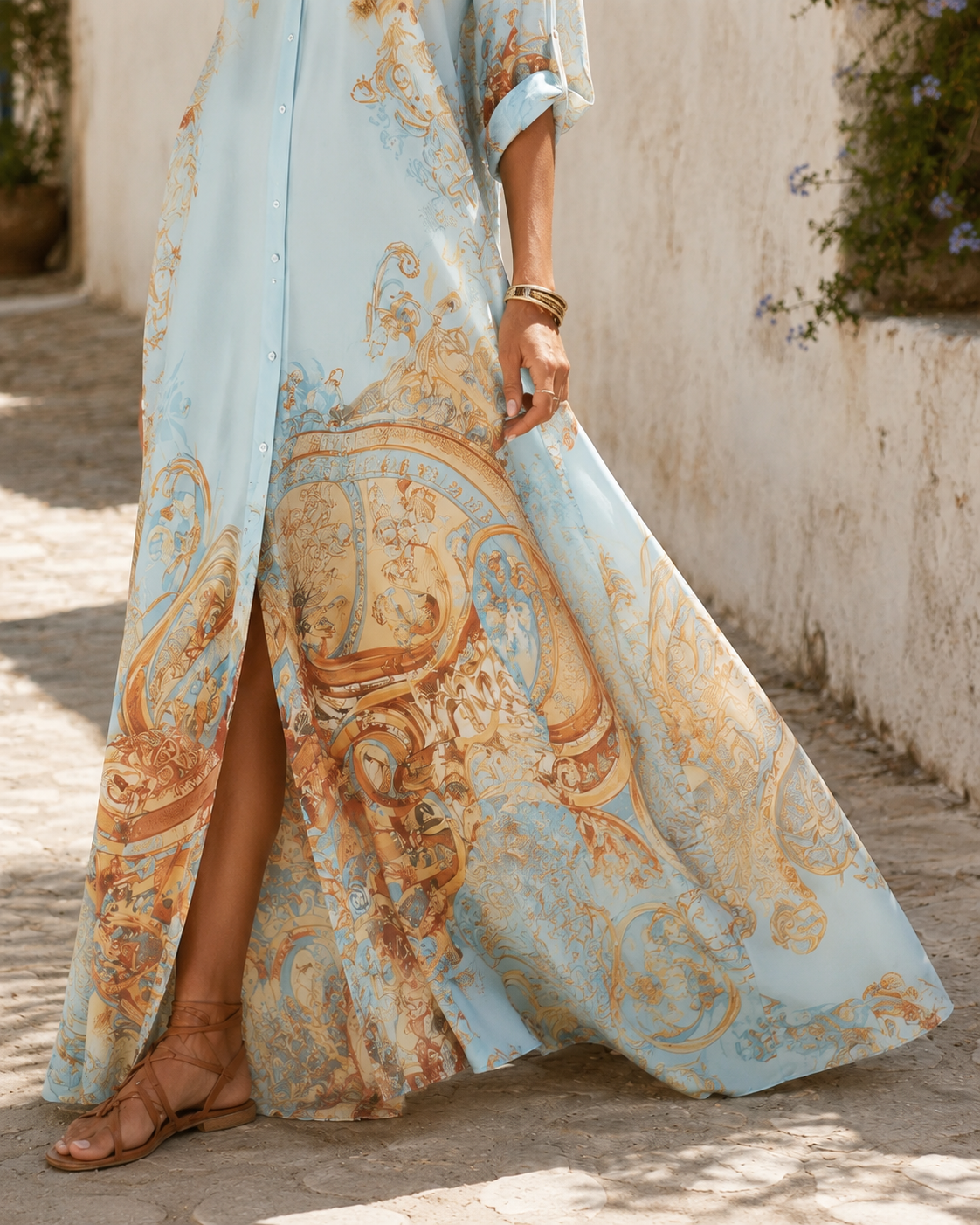 The skirt in motion, showing the slit opening below the last button and the baroque border filling the lower half.