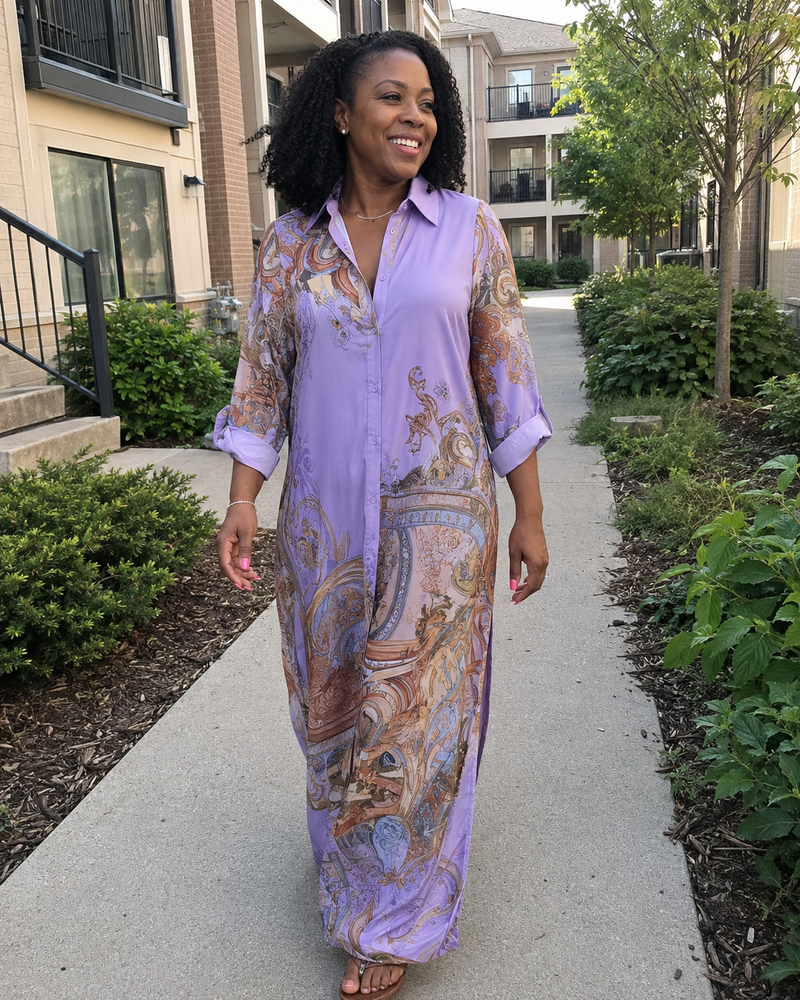 Customer photo: the lilac dress worn walking along a garden path, sleeves rolled to the forearm.