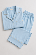 Flat lay of the Still Nights Modal Sleep Set in Powder Blue, folded top and trousers