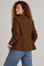 From the back: seamed to the waist, with the buttoned cuffs