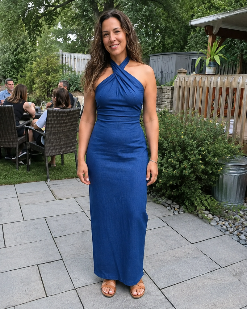 Customer photo: the Noelle dress in dark blue in a garden, full length with flat sandals