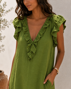 Close-up of the Rosalie bodice: ruffle trim along the V neck and over the shoulder, hand in the side pocket