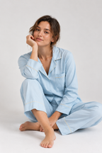 Woman sitting cross-legged in the Still Nights Modal Sleep Set in Powder Blue