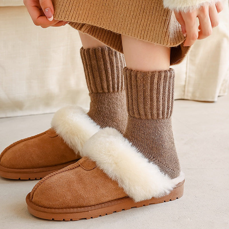 Maud knit socks worn with slippers, ribbed cuff pulled up