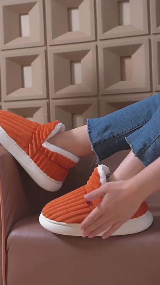 Video with captions: Pluffy corduroy slippers worn at home, with close-ups of the plush fleece lining, the fold-over collar and the rubber sole